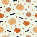 Seamless autumn Halloween pattern with orange pumpkins, bats and leaves on beige background. Royalty Free Stock Photo